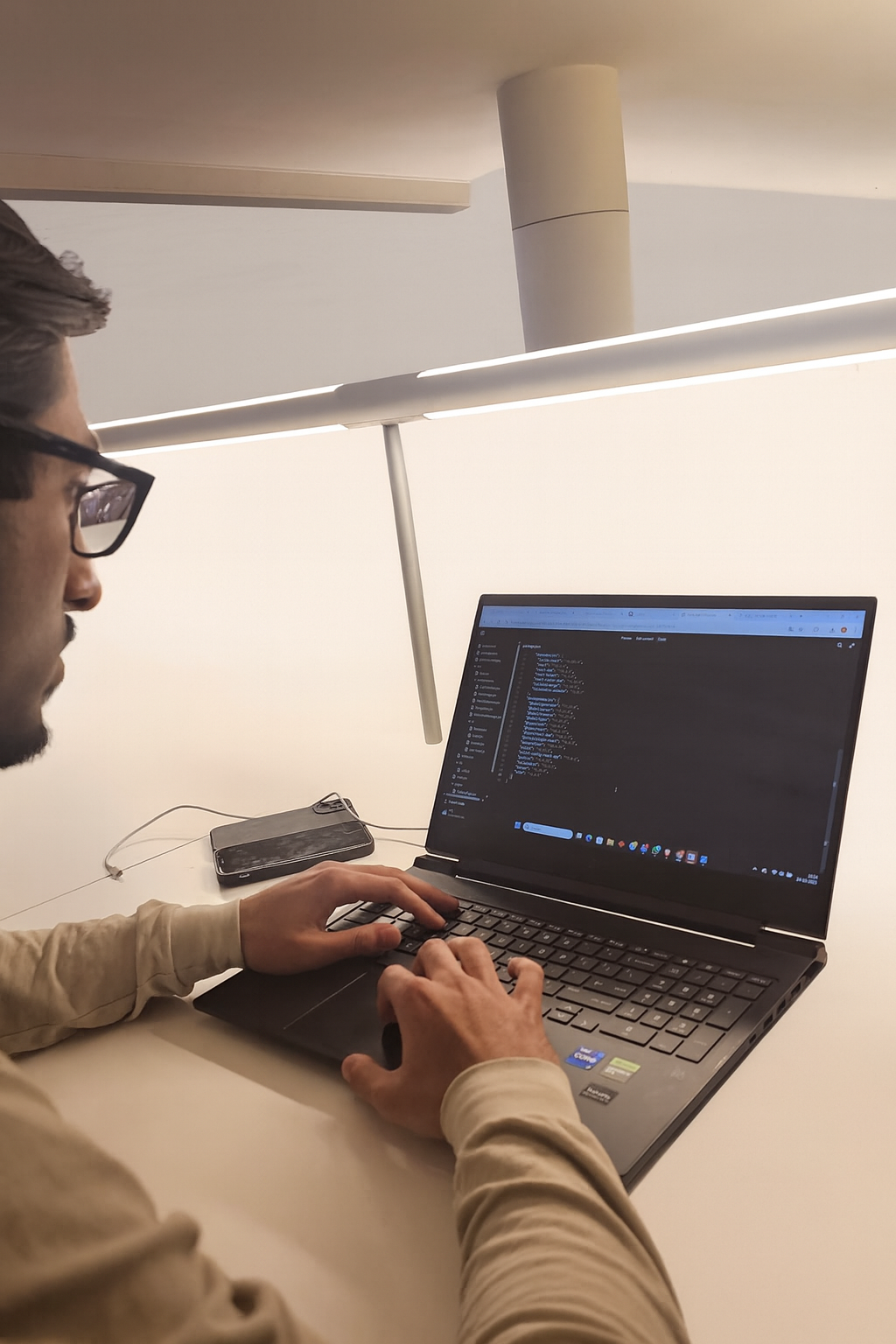 Developer coding at minimalist workspace